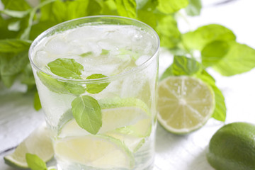 Mojito drink cocktail with rum, limes, mint and ice cubes