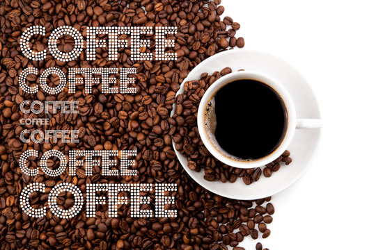 Fototapeta cup of black coffee with roasted beans