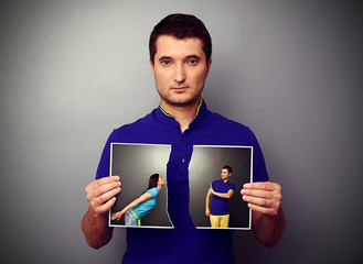 man tearing the photo of couple