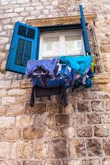 Drying laundry by hanging it on the rope from the window