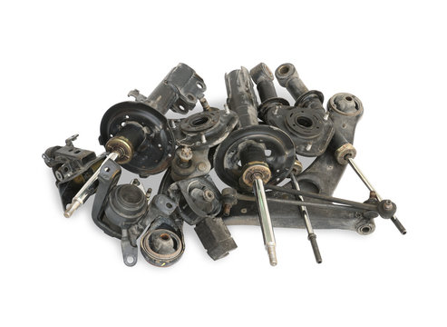 Pile of used auto parts isolated on white background