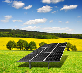 Solar energy panels against blue sky with clouds
