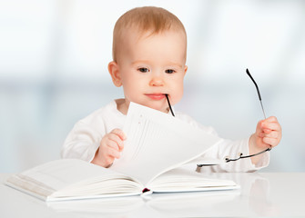 funny baby reading a book