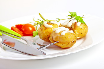 Baked potato with sour cream sauce, selective focus