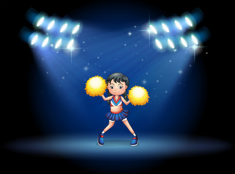 A stage with a young cheerdancer at the center