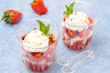 dessert with cookies, berry puree, strawberries and cream