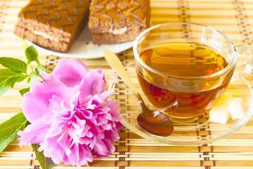 cup of tea and pink flower