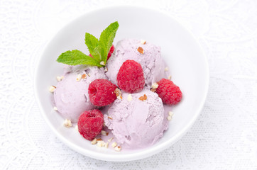 ice cream with fresh raspberries in a bowl