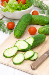 ingredients for salad - fresh cucumbers, tomatoes and fresh herb
