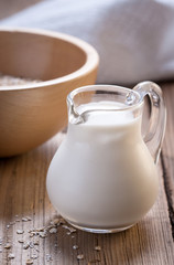Wooden bowls and a small jug on the wooden background