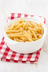 dry penne in white bowl