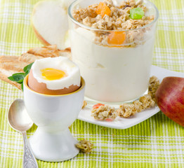 Healthy breakfast - boiled egg , yogurt with muesli