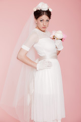 Retro romantic bride in white wedding dress. Decorated with flow