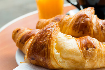 Breakfast with coffee and croissants