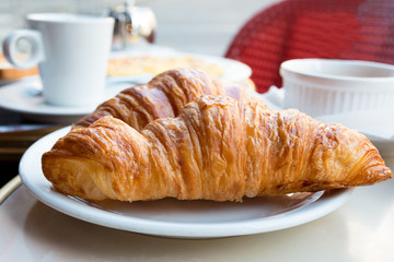 Breakfast with coffee and croissants
