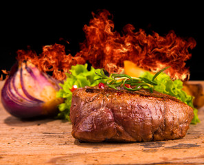Grilled steaks on wood