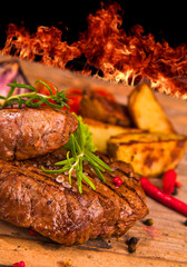 Grilled steaks on wood