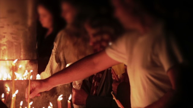 Religious people lighting candles