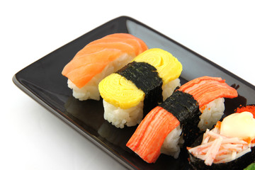 Sushi made ​​from seafood on Black dish.