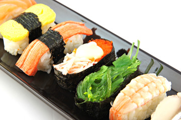Sushi made ​​from seafood on Black dish.