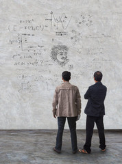 two man standing and watching formula on wall