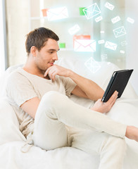 man sitting on the couch with tablet pc