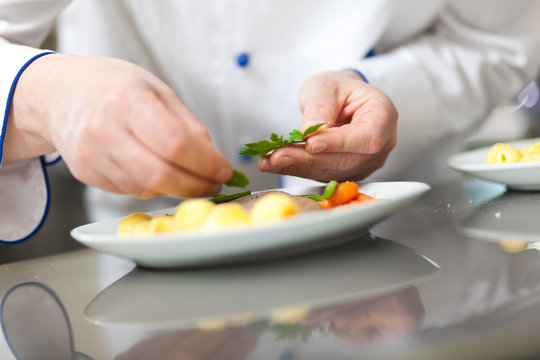 Chef garnishing a dish