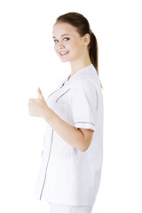 Young female doctor or nurse gesturing OK