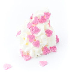 Vanilla soft ice cream decorated with love sweet hearts on white