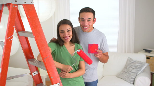 Happy Mexican couple doing home improvements