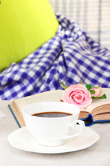 Composition with cup of drink, book and flowers
