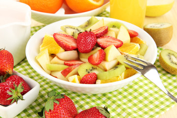 Useful fruit salad of fresh fruits and berries in bowl