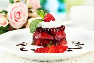 Tasty jelly dessert with fresh berries, on bright background