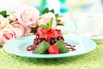 Tasty jelly dessert with fresh berries, on bright background