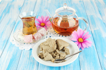 Tasty halva with tea on table