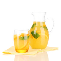 Orange lemonade in pitcher and glass isolated on white