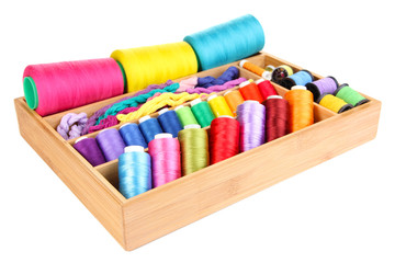Colorful threads for needlework in wooden box isolated on white