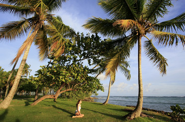 Young woman sitting at Las Galeras beach, Samana peninsula