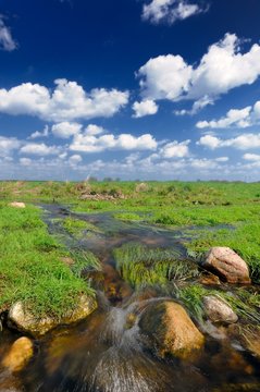 Water Stream in the Field and Blue Sky