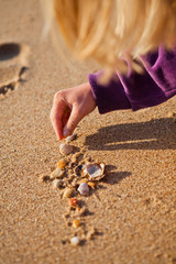 Young girl playing with shells
