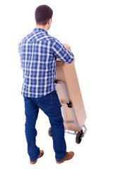 Fototapeta premium Young casual man moving a boxe with dolly, isolated on white bac