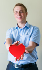 young guy holding a heart