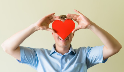 young guy holding a heart