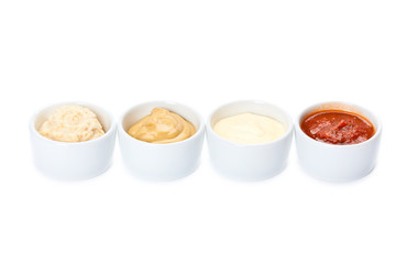 several types of sauce on a white background