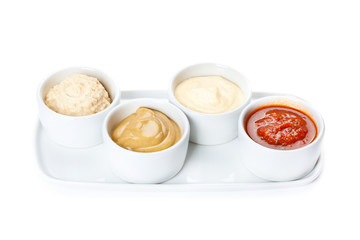 several types of sauce on a white background