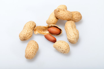 .Dried peanuts in closeup on the white background