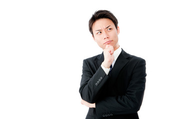 ちょっと上を向いて考える若いビジネスマン