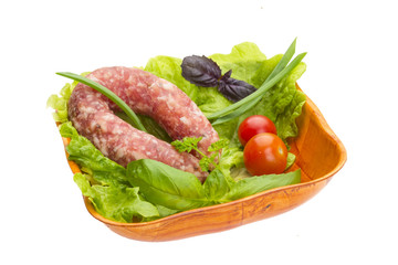 Ripe salami with salad, basil, onion and tomato