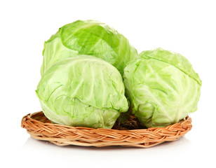 Fototapeta premium Green cabbage on wicker mat, isolated on white