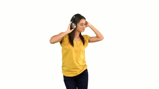 Woman dancing with headphones on white background